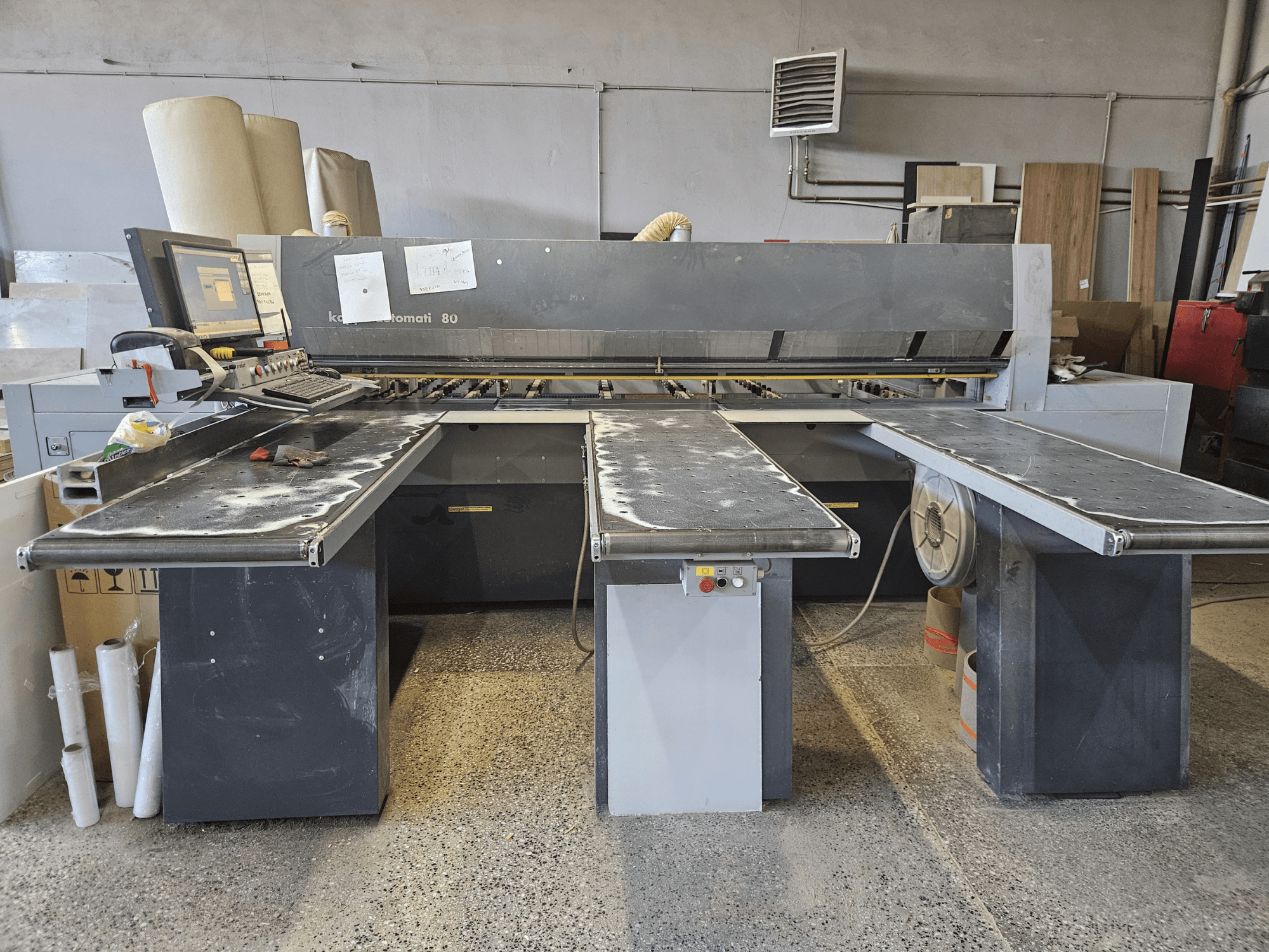 KAPPA Automati 80 machine, front view, with three flat tables, control panel, and scattered sawdust on surfaces.
