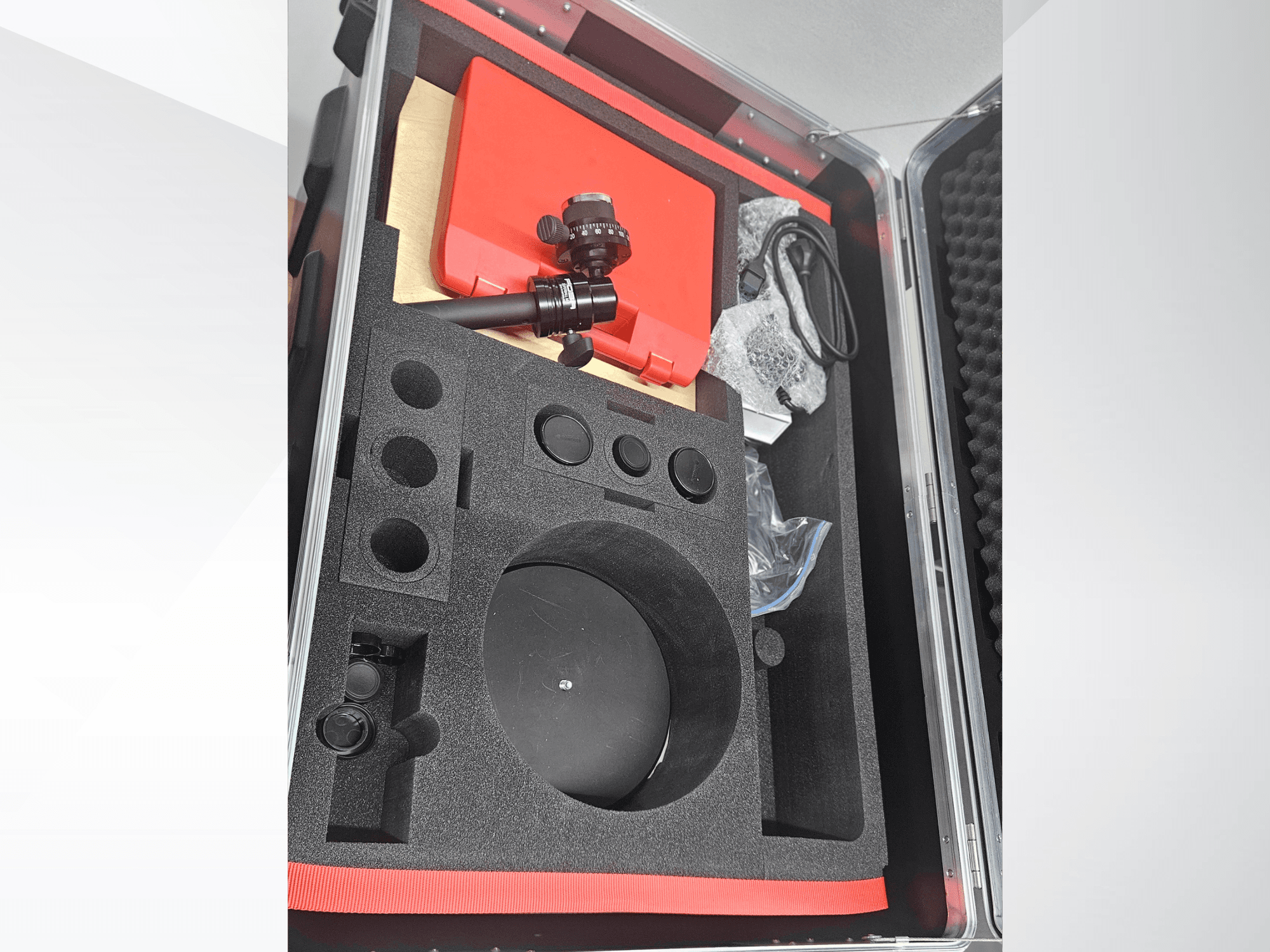 ZEISS GOM ATOS 5 optical measurement machine components in a foam-lined case, featuring a lens, accessories, and protective packaging.