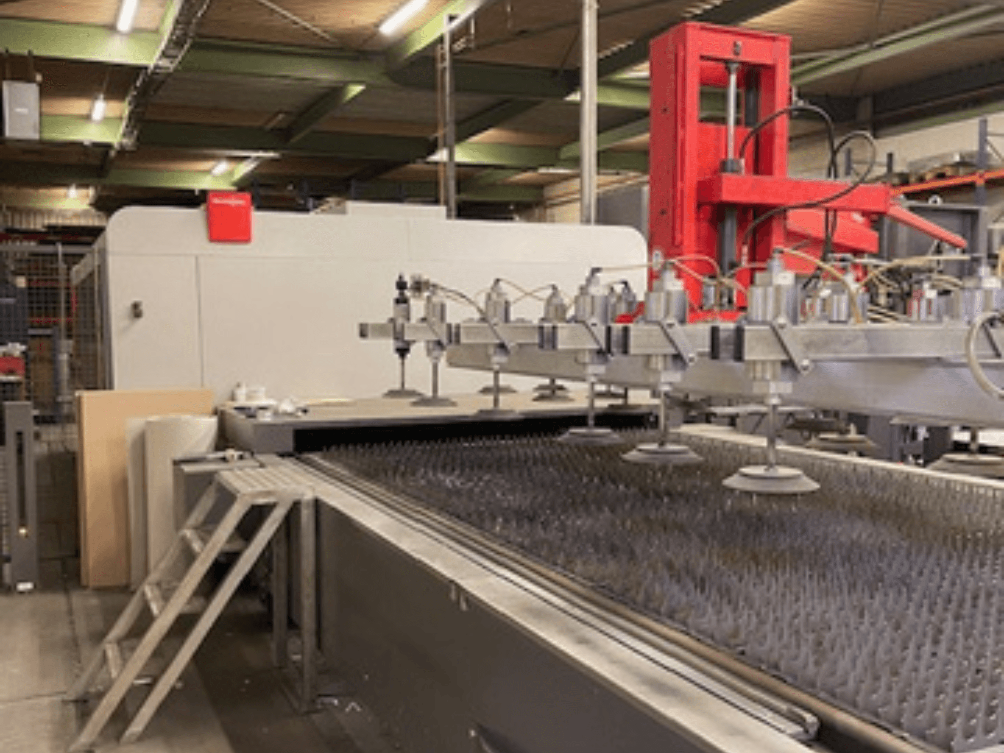 Bystronic BySprint Fiber 4020 Fiber 4Kw front view of a fiber laser cutting machine with nozzles and cutting bed.