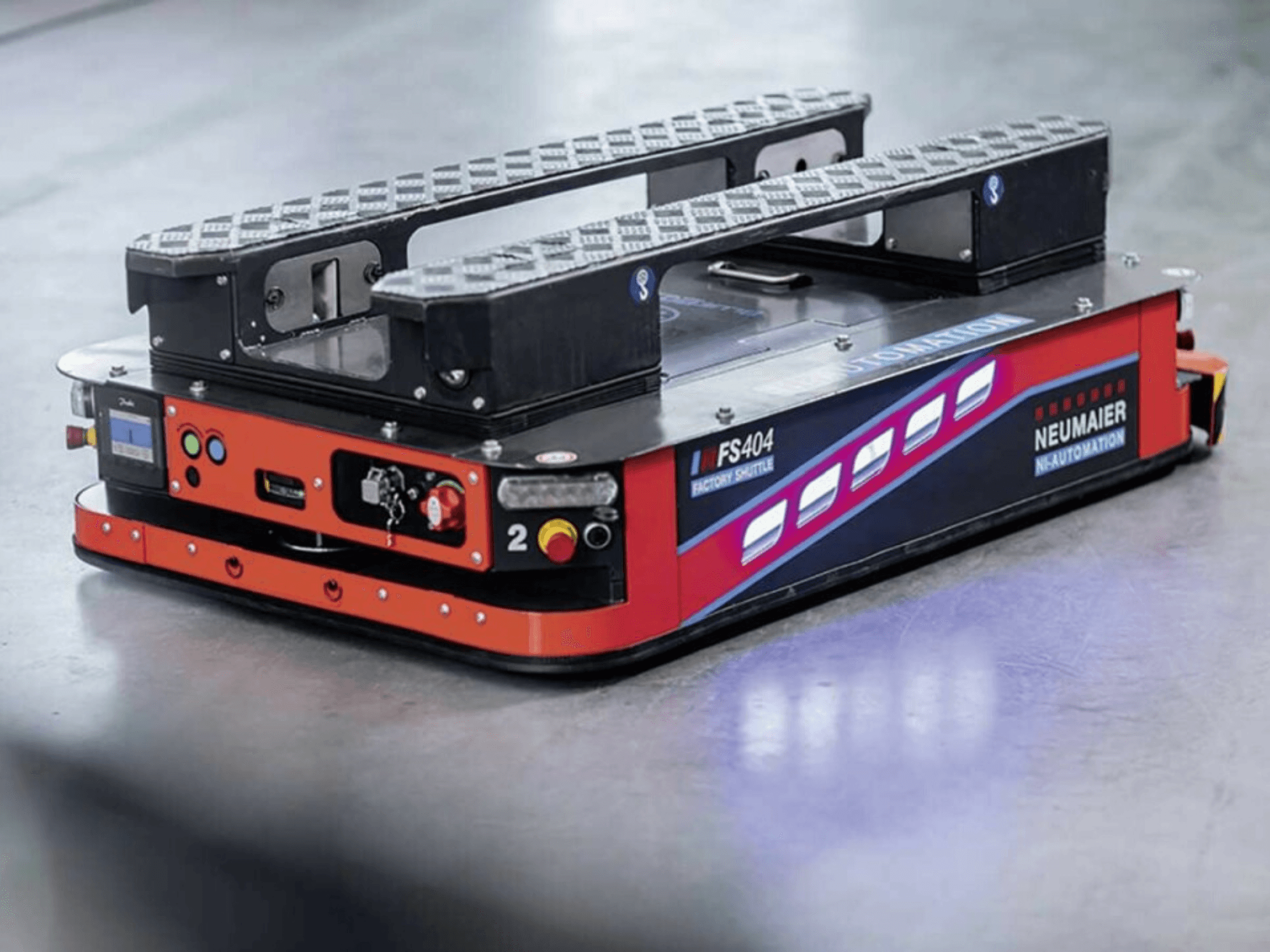 NEUMAIER AGV Factory Shuttle FS404, low-profile pallet handling system, side view showing wheels, controls, and safety features.