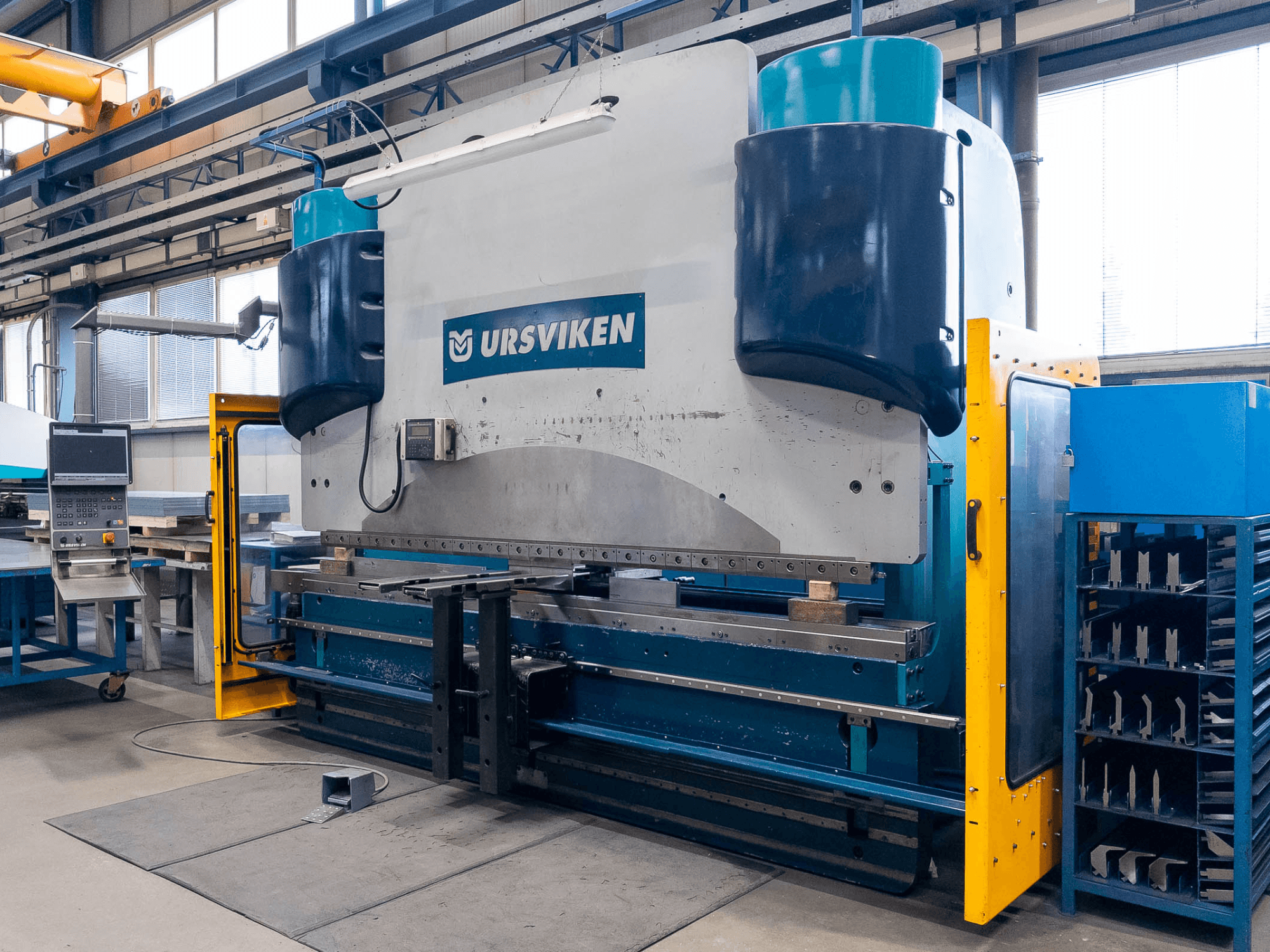 Ursviken Optiflex 130 3.1M press brake in a manufacturing setting, showcasing front view and control panel.