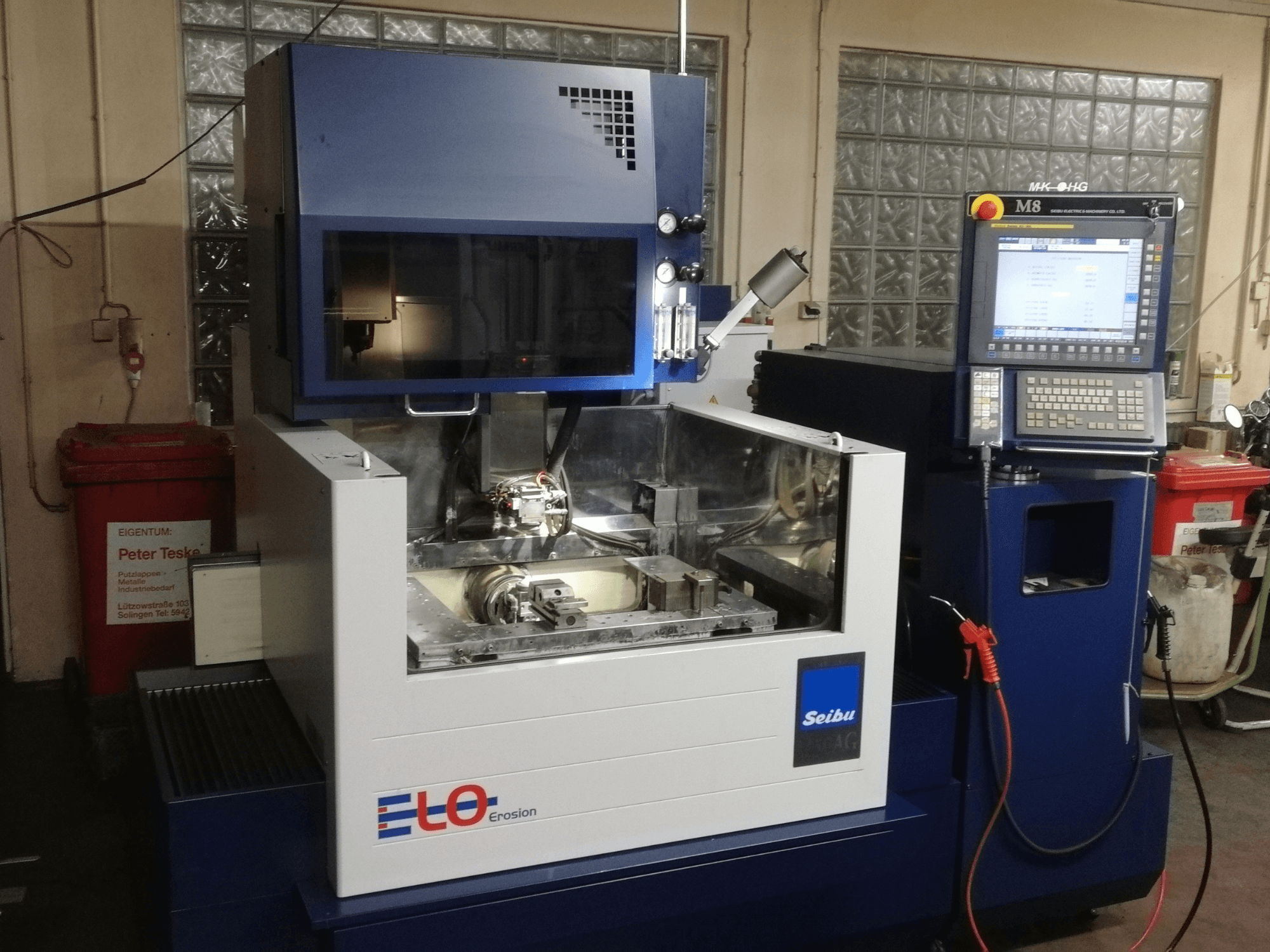 ELO Seibu erosion machine seen from the front, featuring a control panel and visible work area with metal components.